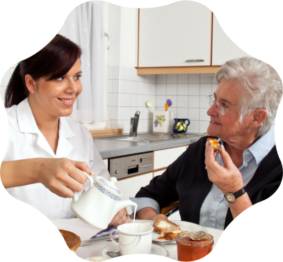 A caregiver sharing a meal with a resident